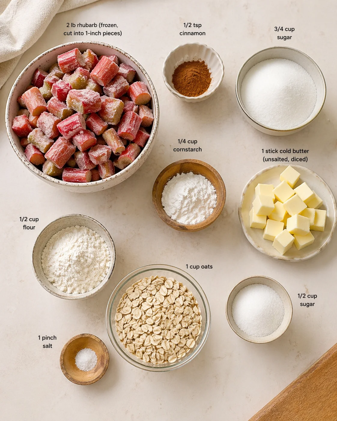 Measured ingredients arranged for Classic Rhubarb Crisp with Frozen Rhubarb: 2 lb rhubarb (frozen, cut into 1-inch pieces), 1/2 tsp cinnamon (adds a cozy, warm spice flavor), 3/4 cup sugar, 1/4 cup cornstarch (helps thic