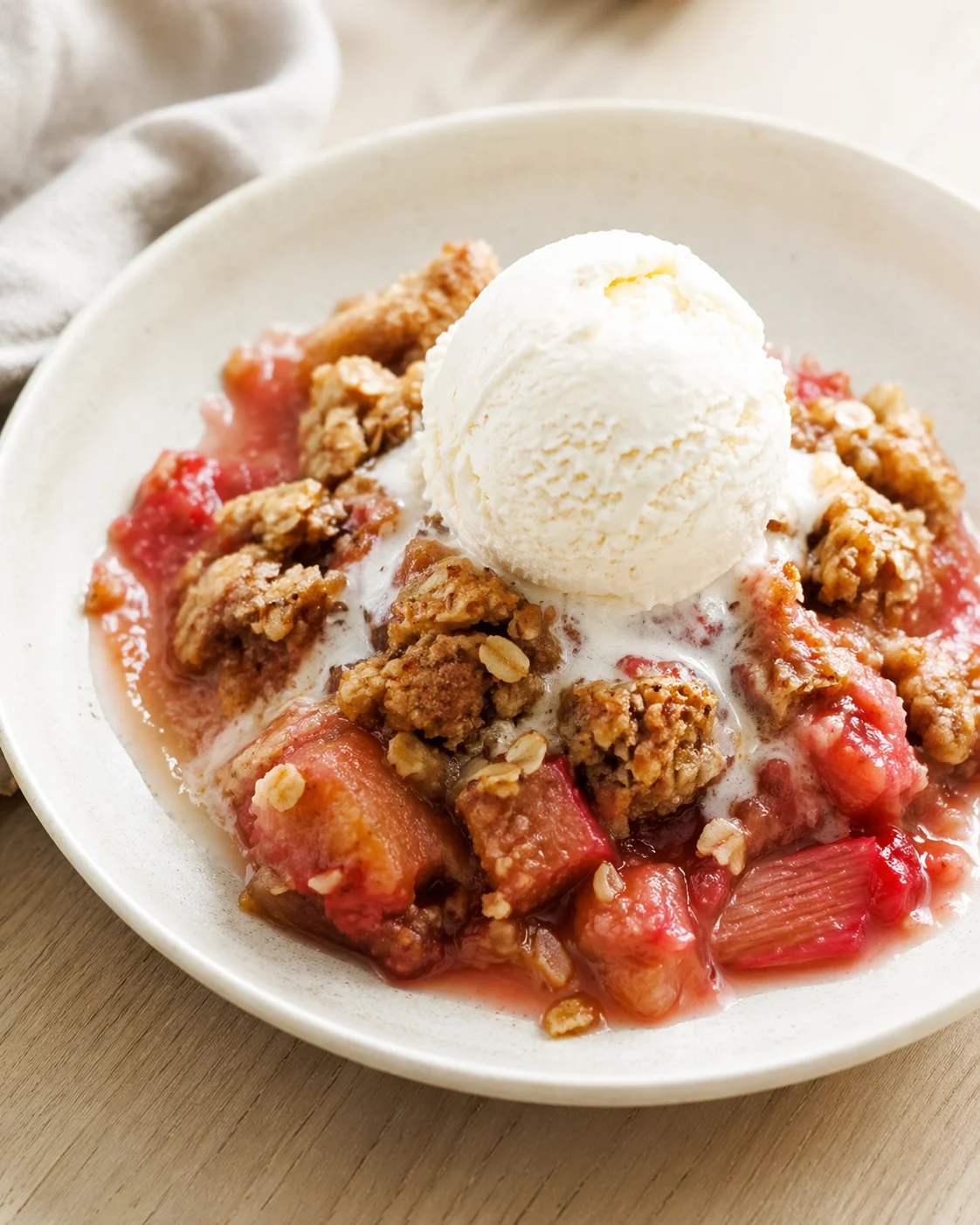 Single plated variation of Classic Rhubarb Crisp with Frozen Rhubarb shown in a natural kitchen scene