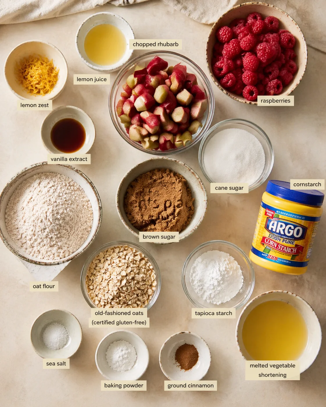 Measured ingredients arranged for Easy Gluten Free Rhubarb Bars: zest and juice of 1 lemon (freshly zested and squeezed for the brightest flavor), 1/2 tsp vanilla extract, 1/3 cup plus 1 tbsp cane sugar, 2 cups chopped r