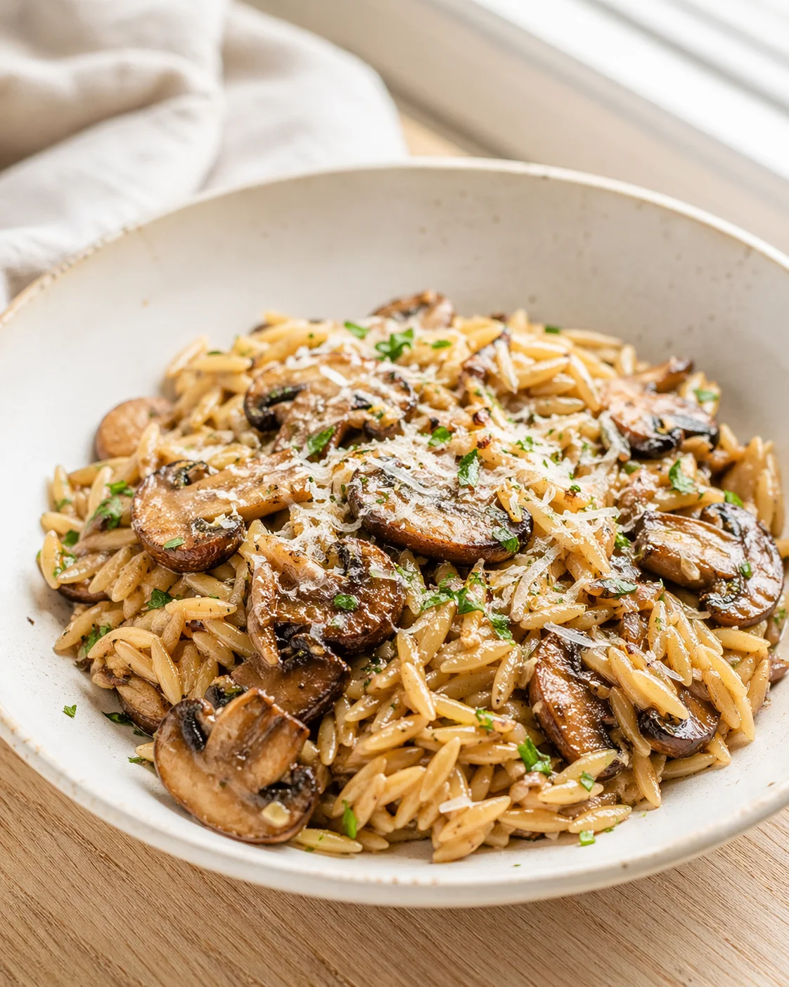 Single plated variation of Tasty Orzo with Mushrooms shown in a natural kitchen scene
