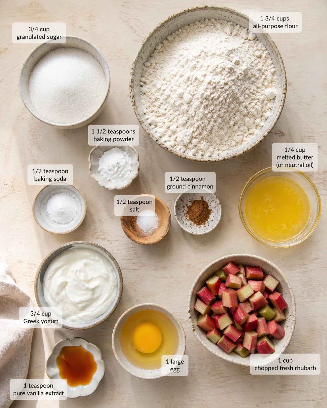 Measured ingredients arranged for Rhubarb Muffins with Yogurt: 1 3/4 cups all-purpose flour, 3/4 cup granulated sugar, 1 1/2 teaspoons baking powder, 1/2 teaspoon baking soda, 1/2 teaspoon salt, 1/2 teaspoon ground cinna