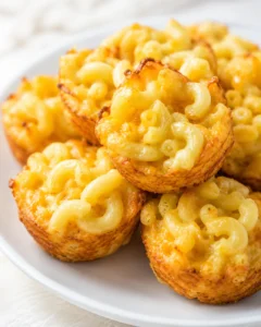 Close-up of crispy cheese cups filled with creamy macaroni and cheddar cheese.