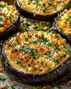 Golden crispy eggplant slices topped with herbs and cheese, fresh out of the oven.