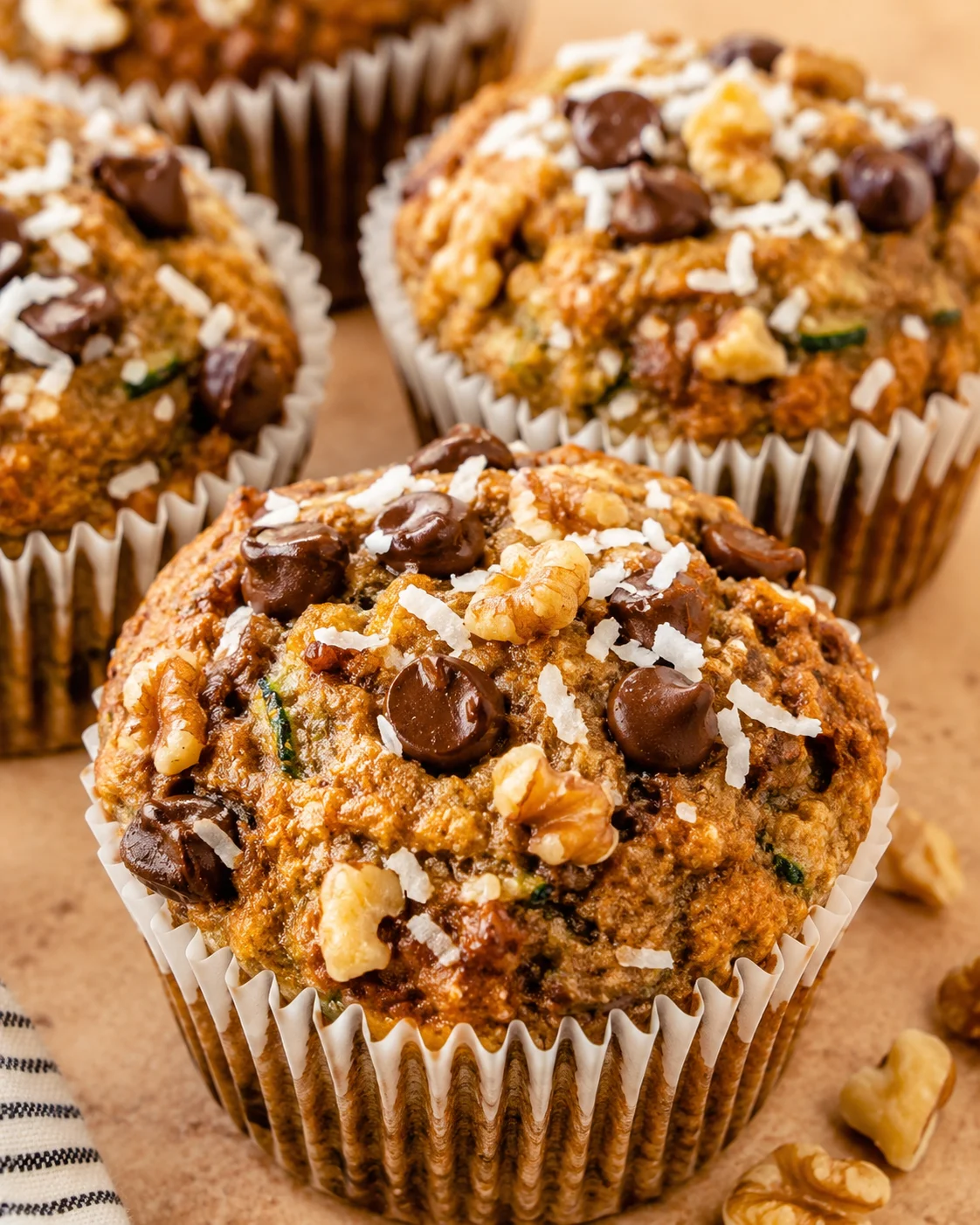 Delicious healthy zucchini banana muffins topped with chocolate chips and coconut flakes.