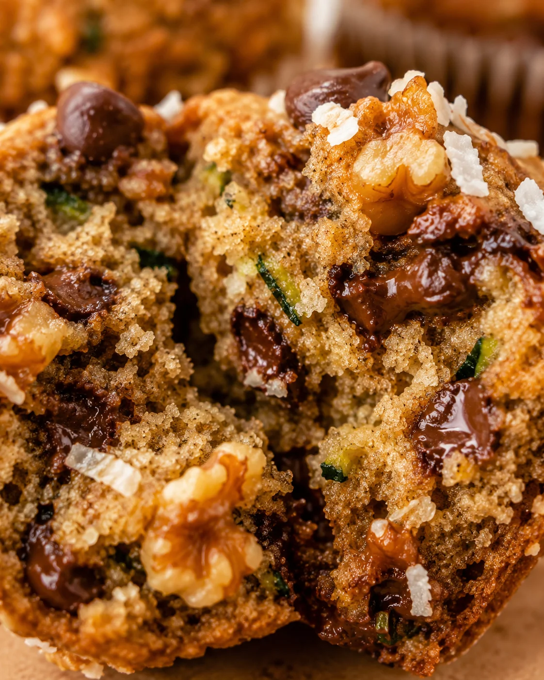 Close-up of delicious chunky monkey zucchini banana muffins loaded with chocolate chips and nuts