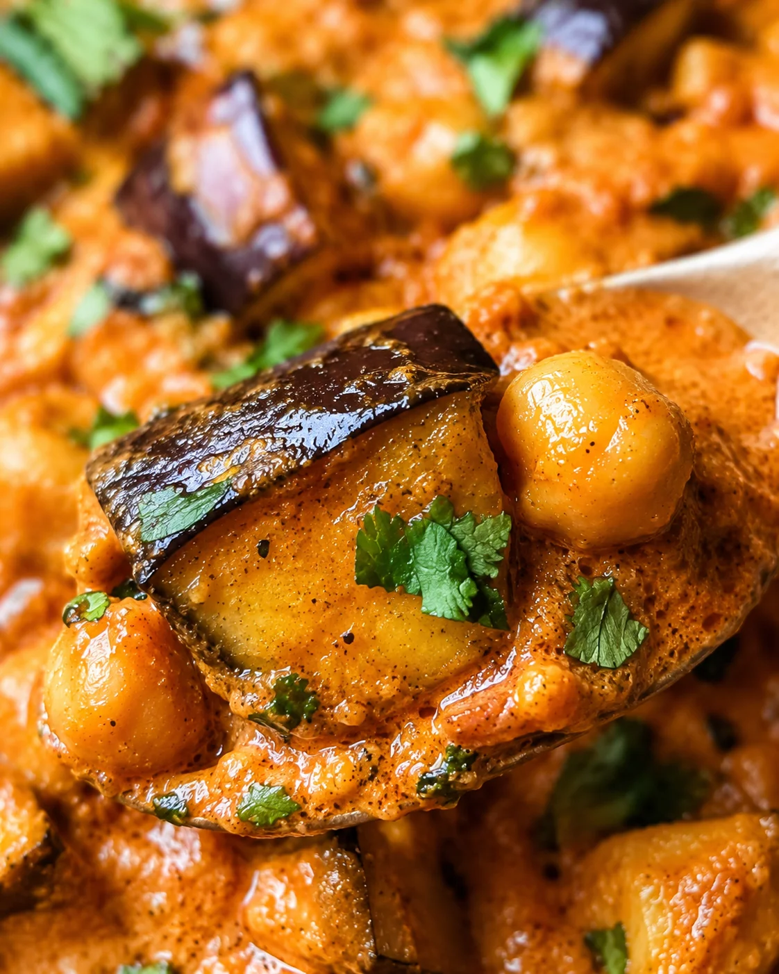 Creamy roasted eggplant cubes in a flavorful Indian tomato sauce garnished with herbs