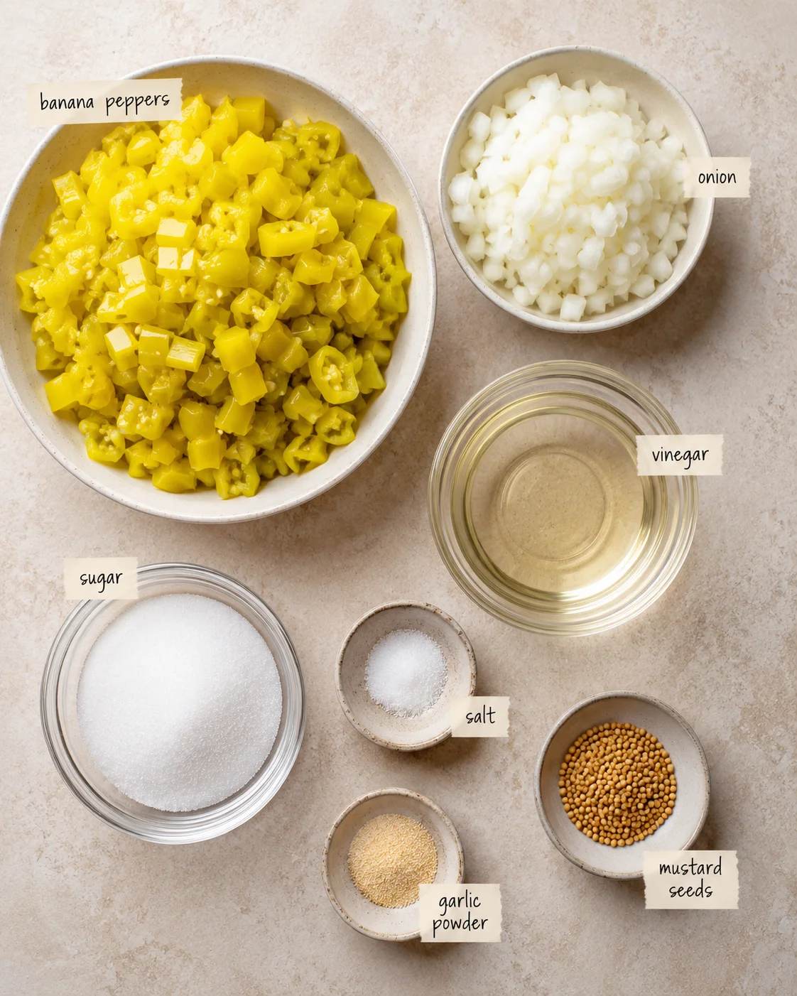 Assortment of chopped banana peppers, onions, vinegar, sugar, and spices for relish
