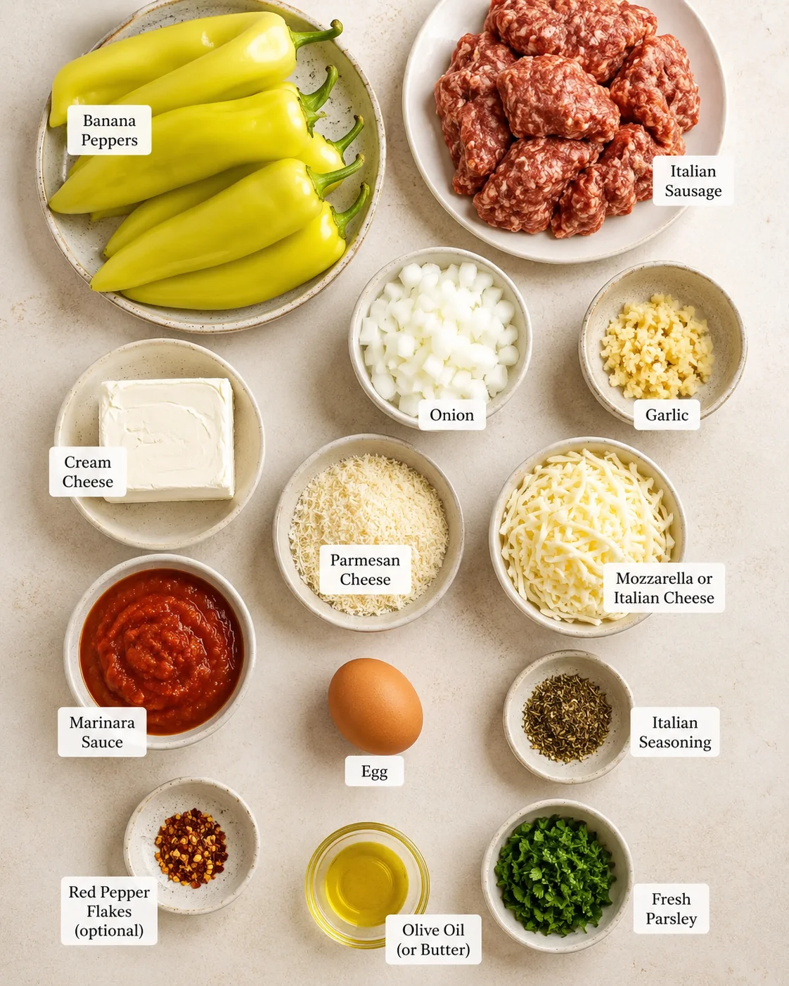 Ingredients for Italian sausage stuffed banana peppers including peppers, sausage, cheese, and seasonings.