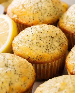 Close-up of freshly baked lemon poppy seed muffins with bright lemon glaze.