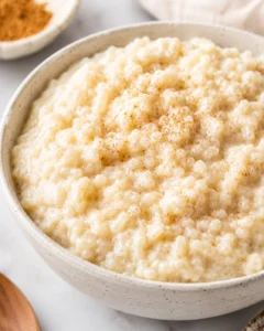 Delicious creamy rice pudding served in a bowl, topped with cinnamon.