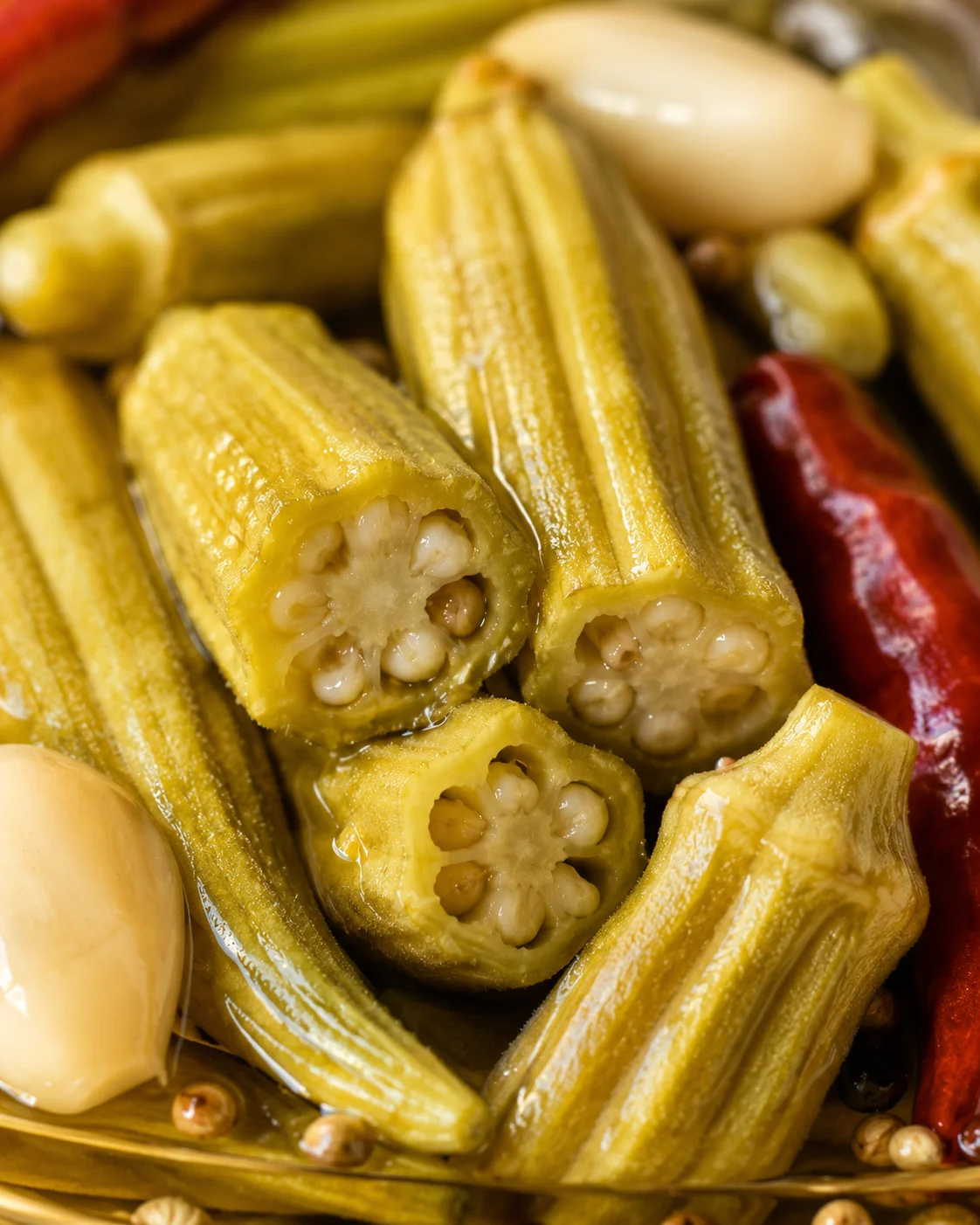 Close-up of vibrant, sliced pickled okra pods showcasing their interior texture.