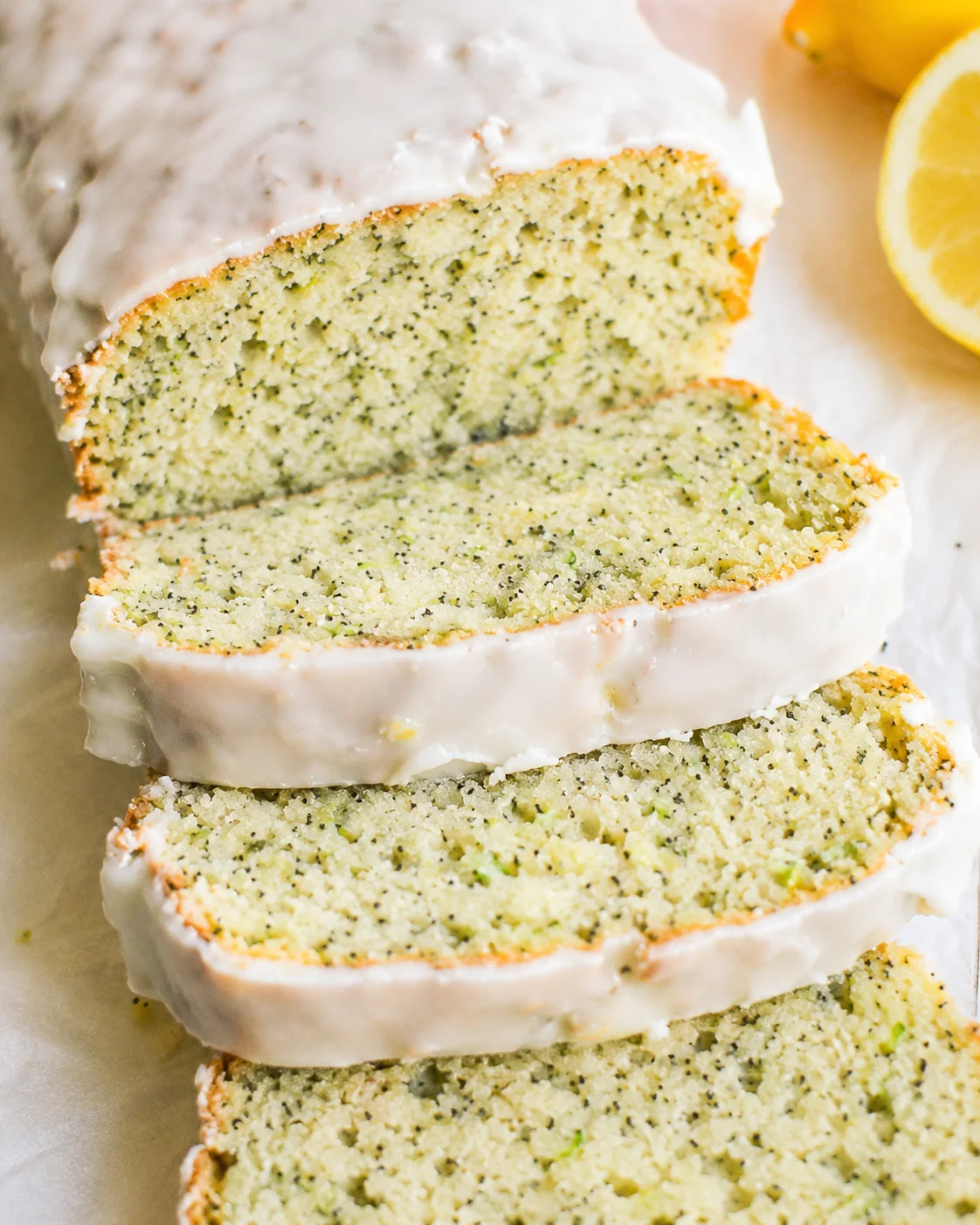 Freshly baked lemon zucchini bread with poppy seeds and a lemon glaze on top