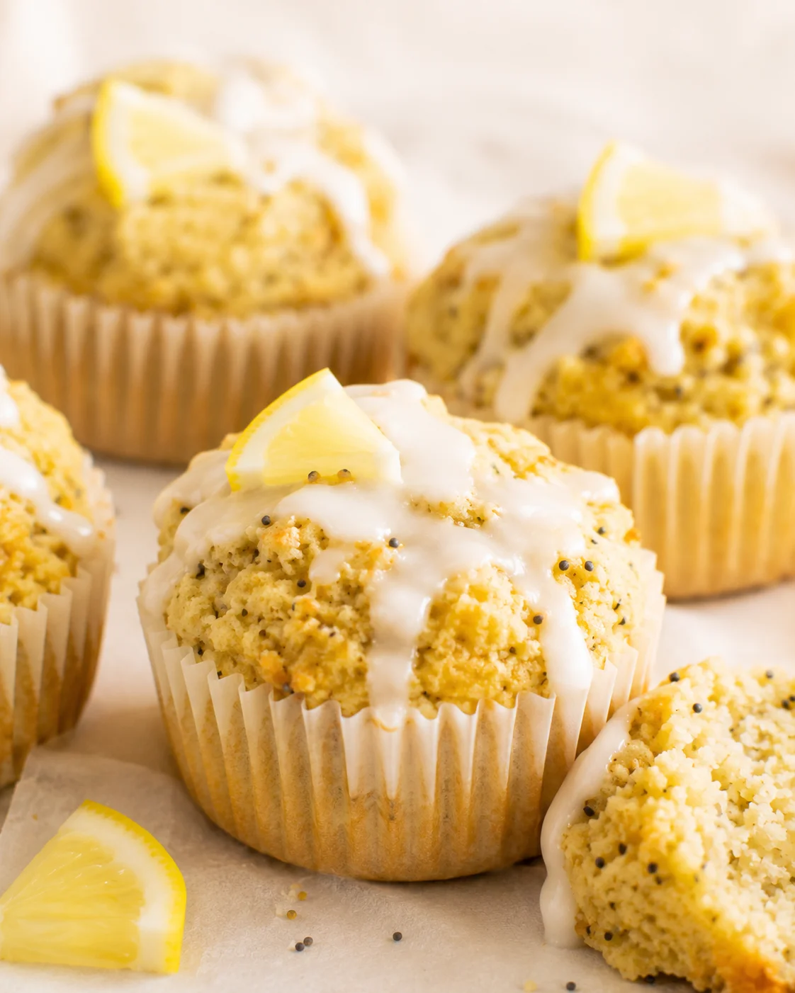 Delicious lemon poppy seed muffins topped with lemon glaze and lemon wedges