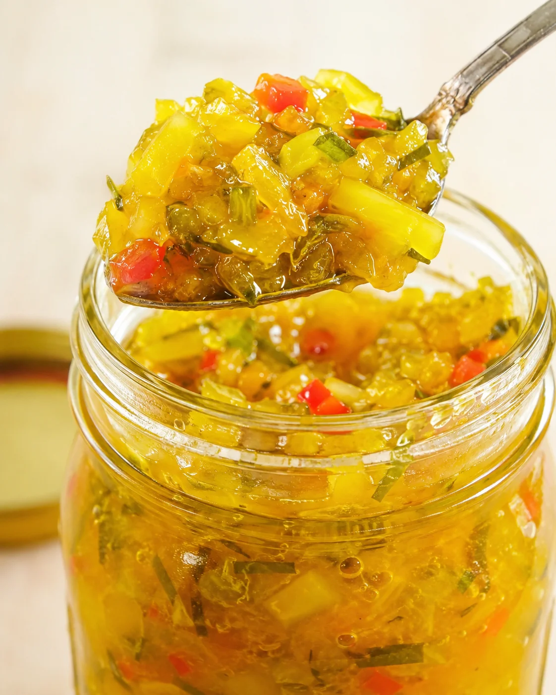 Sweet Spicy Zucchini Relish Recipe Colorful jar of homemade sweet and spicy zucchini relish with vegetables and spices