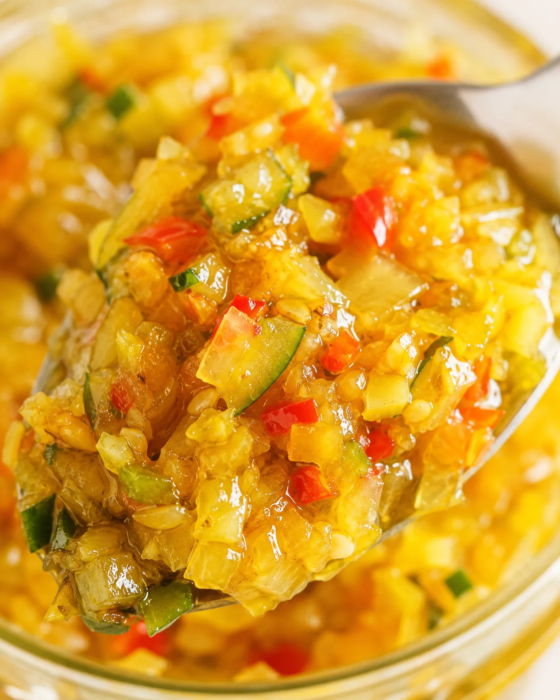 Sweet Spicy Zucchini Relish Colorful spoonful of homemade sweet and spicy zucchini relish with peppers and spices