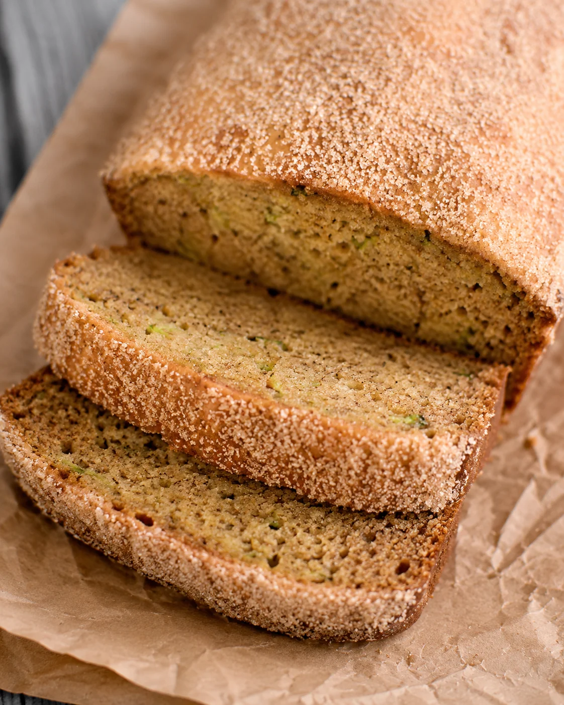 Two loaves of moist, cinnamony zucchini bread with sugar-crusted tops.