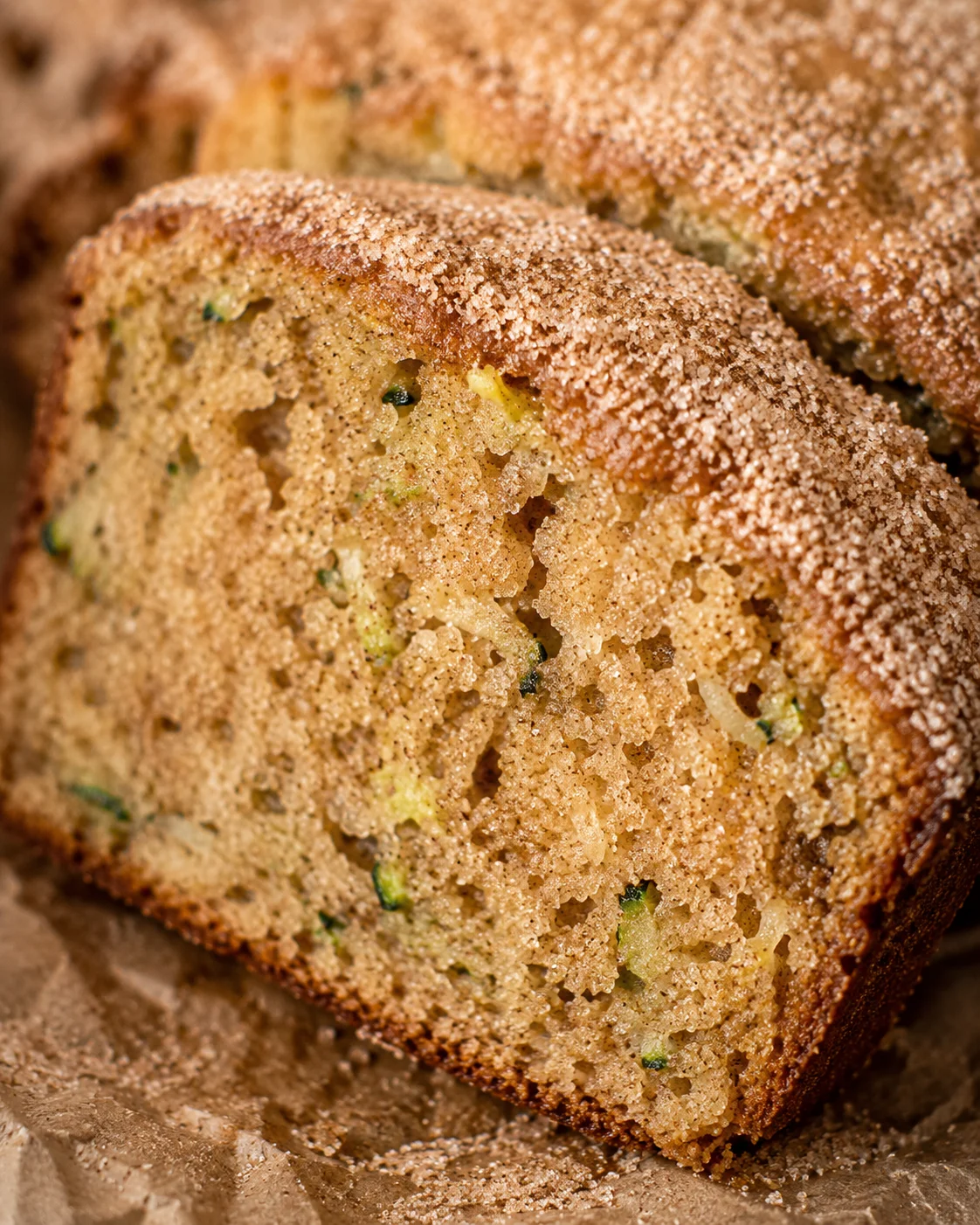 Moist, cinnamon-sugar topped zucchini bread loaf with a golden crust.