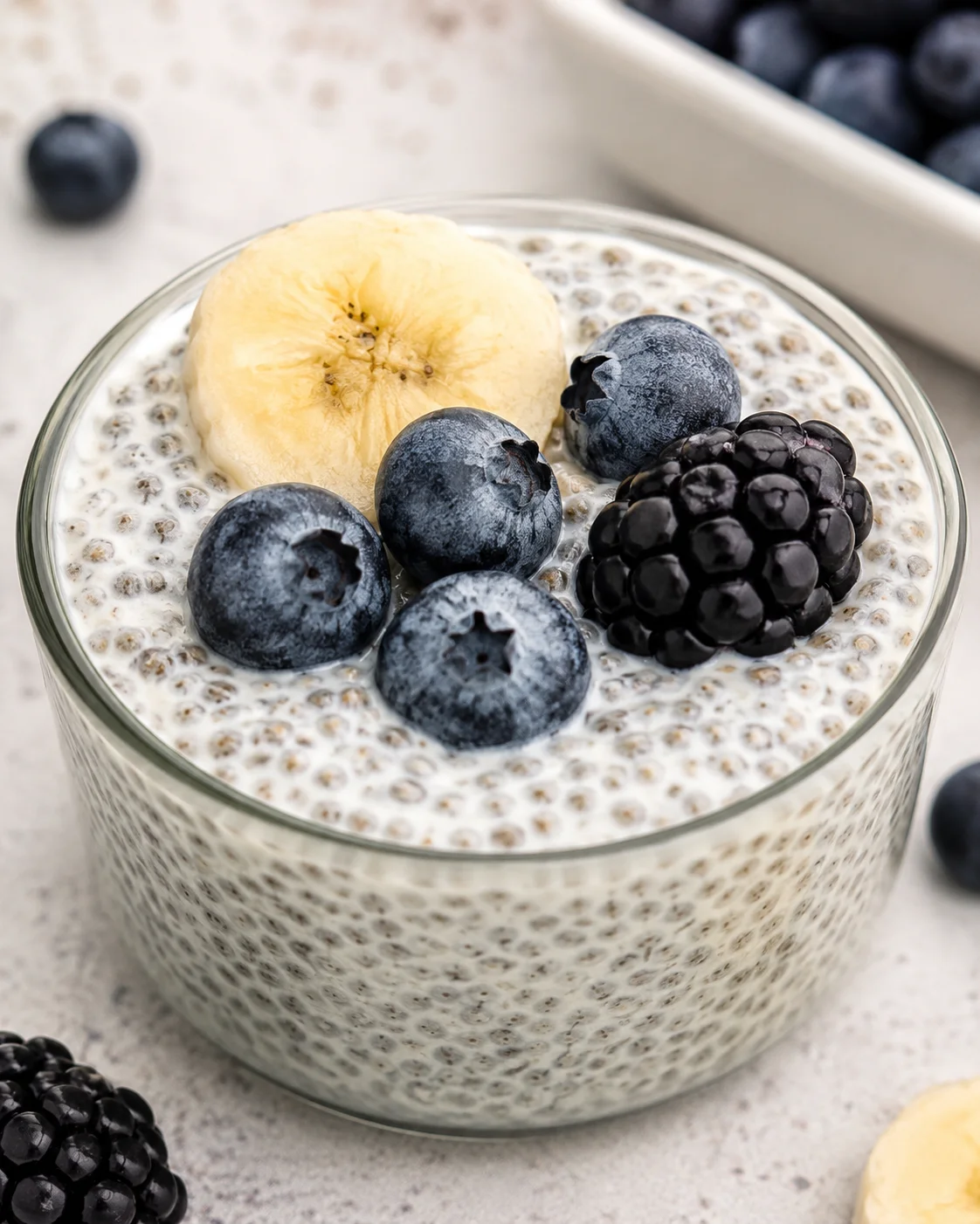 Creamy Vanilla Chia Pudding Close-up of vanilla chia pudding topped with blueberries and banana slices in a glass