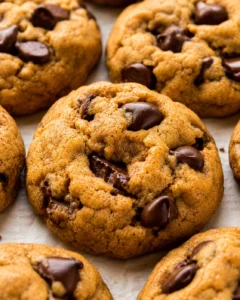 Close-up of chewy pumpkin chocolate chip cookies showing golden-brown tops and chocolate chips