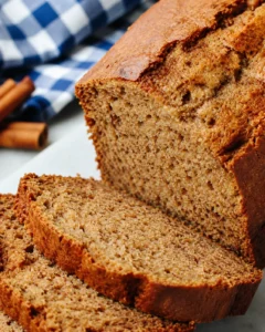 Close-up side view of sliced Cinnamon Applesauce Bread showing crust and interior crumb