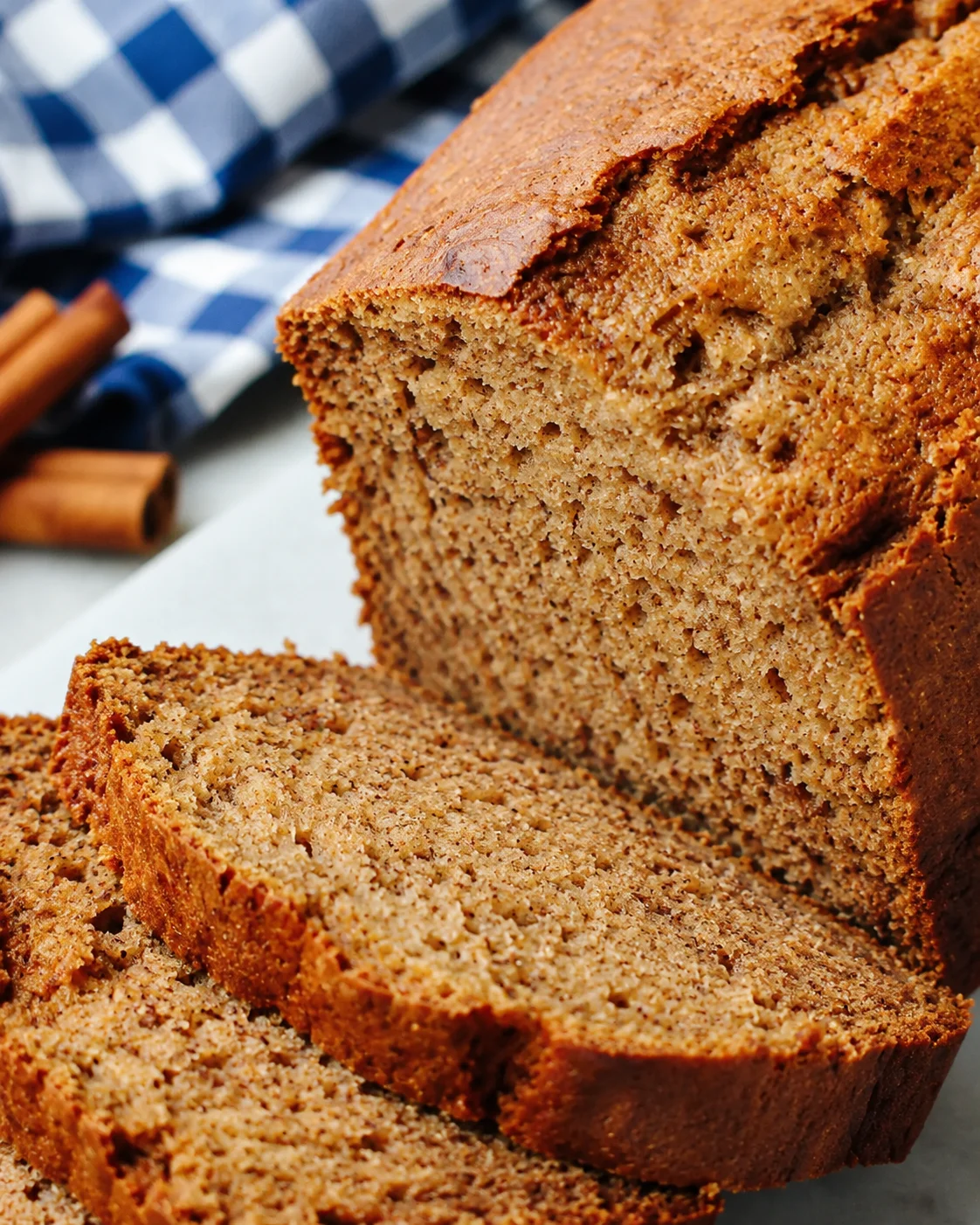 Close-up side view of sliced Cinnamon Applesauce Bread showing crust and interior crumb