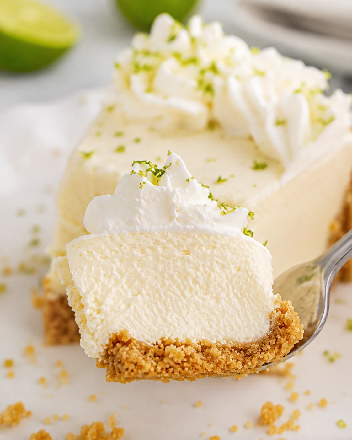 Forkful of no-bake key lime pie showing creamy interior and crumb crust