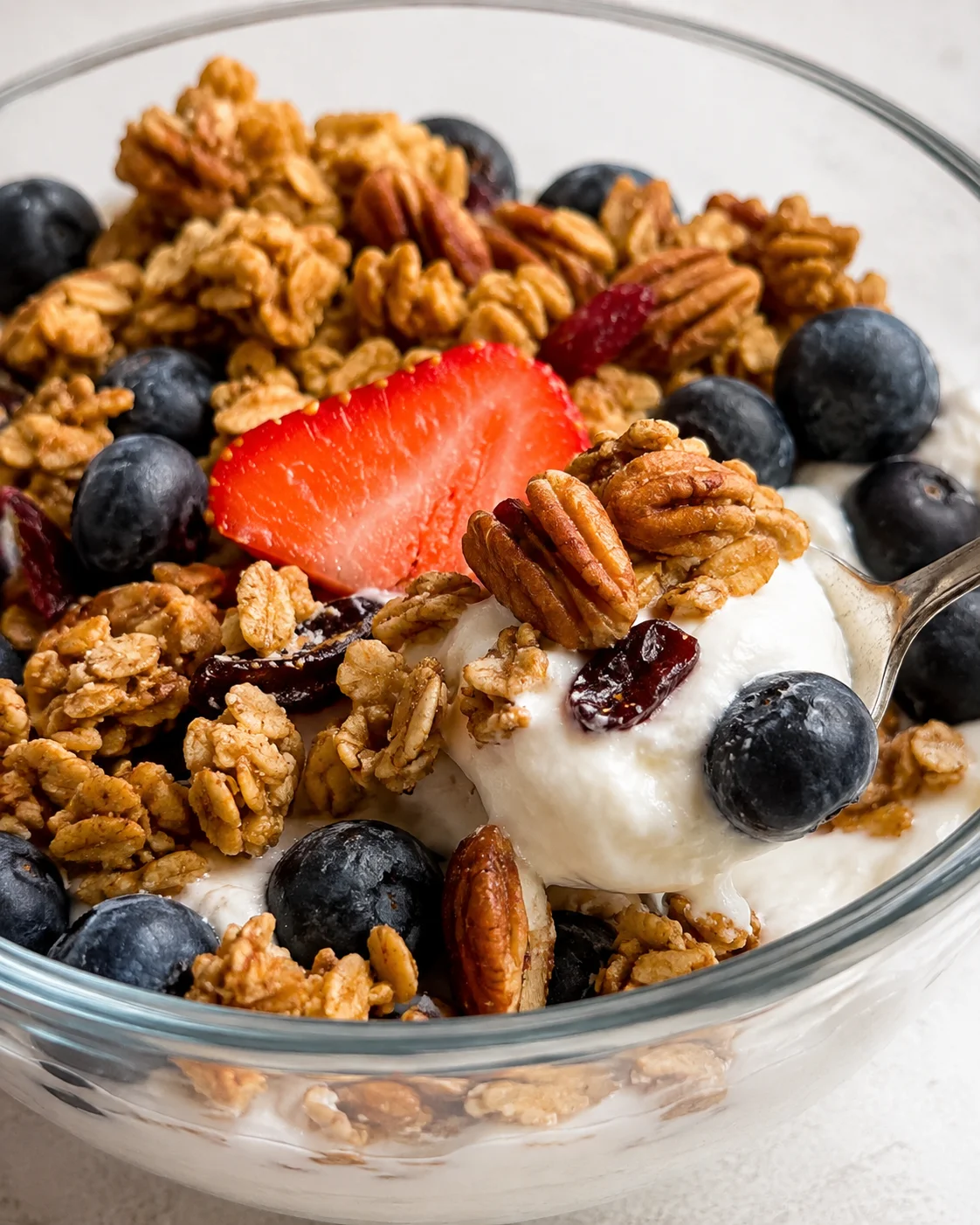 Homemade Sourdough Granola Crunchy sourdough granola with nuts, berries, and yogurt in a glass bowl