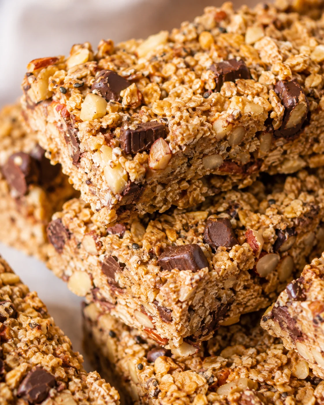 Stacked sourdough granola bars with nuts and chocolate chips close-up