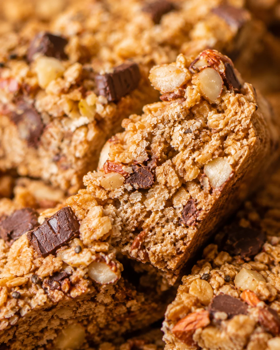 Close-up of homemade sourdough granola bars with nuts, seeds, and chocolate chunks.