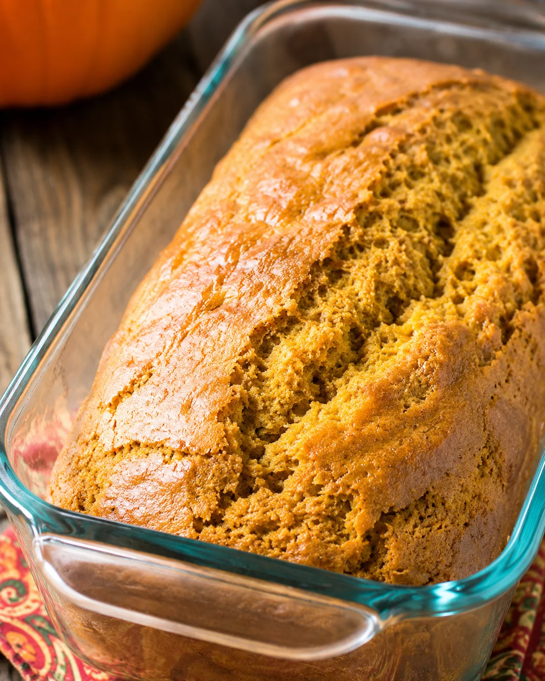 loaf of sweetened condensed milk pumpkin bread in a glass loaf pan, close-up